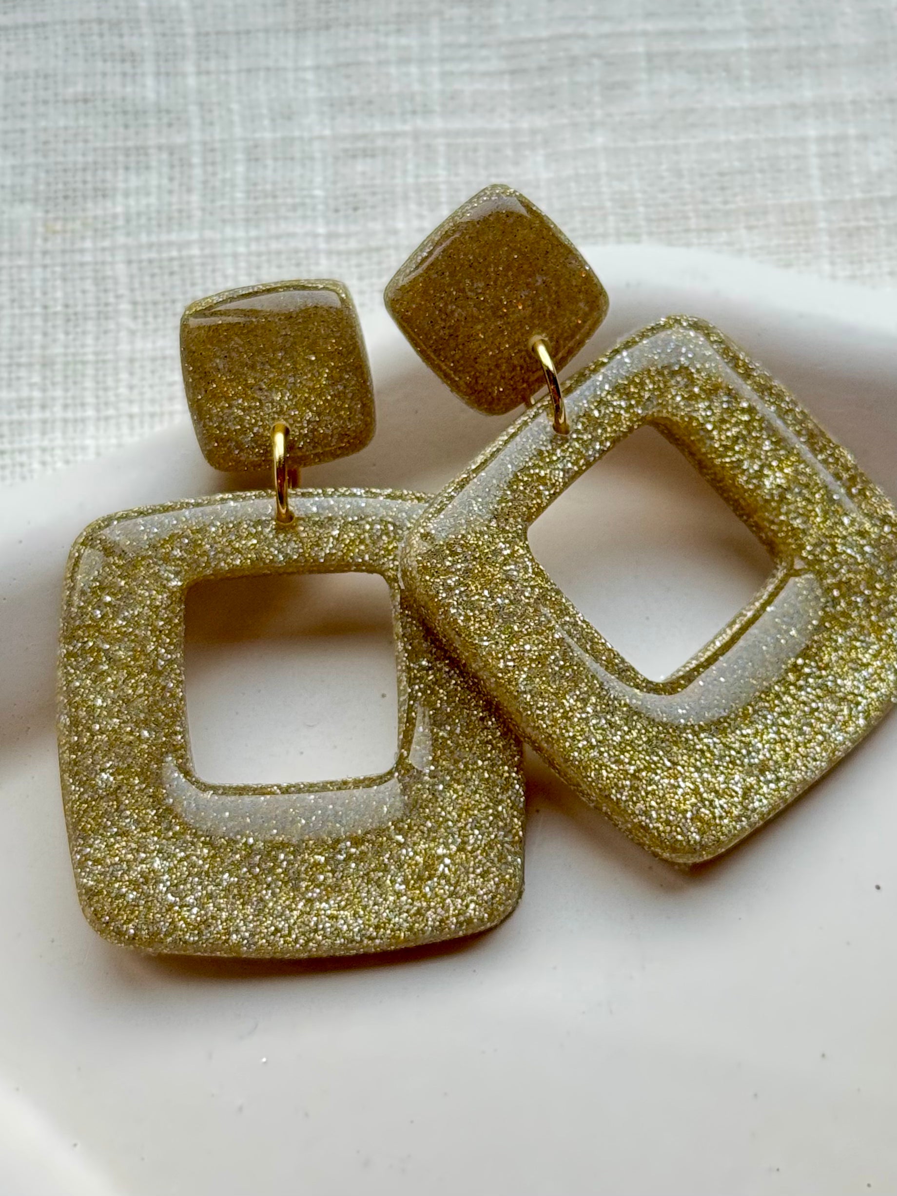 Suzie - Oorbellen glitter goud
